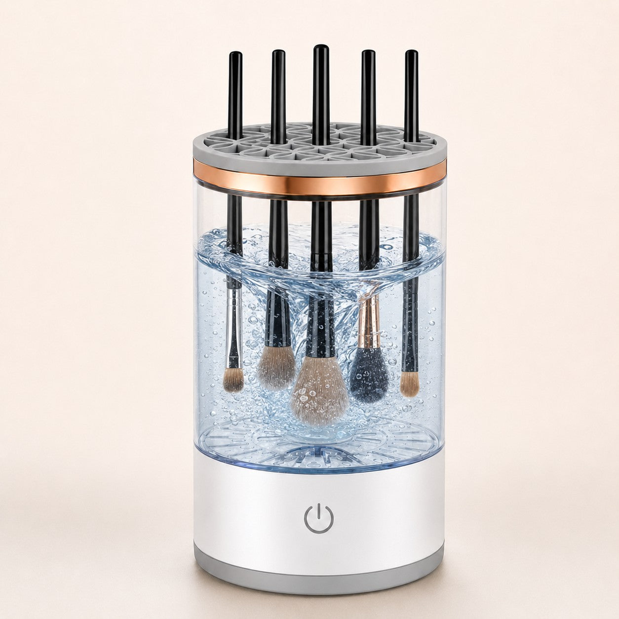 SpinGlow automatic makeup brush cleaner in transparent with makeup brushes